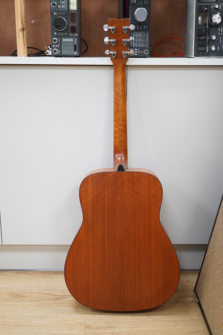 A Yamaha FG700MS acoustic guitar with a soft carry case